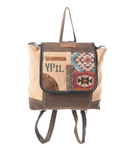 MYRA-Southwest Bound Backpack with vintage VP11 design, sandstone canvas, upcycled rug patterns, leather accents, and dark chocolate handle.