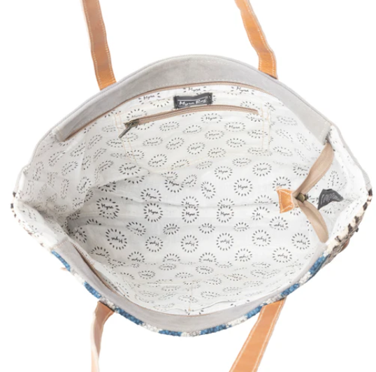 Interior view of MYRA Rhombic Pattern Tote Bag with leather handles, cotton lining, and interior pocket.
