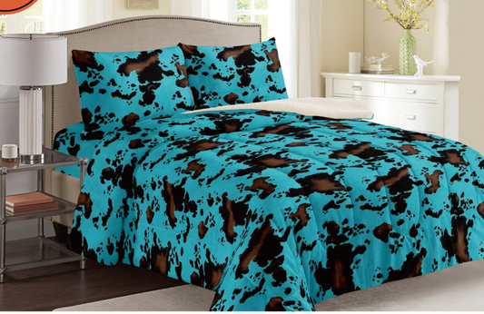 King size turquoise cow print inspired Sherpa blanket set with two shams, featuring an Aztec design.