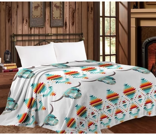 Mia Throw Blanket - White Buffalo Queen size on bed in cozy room.