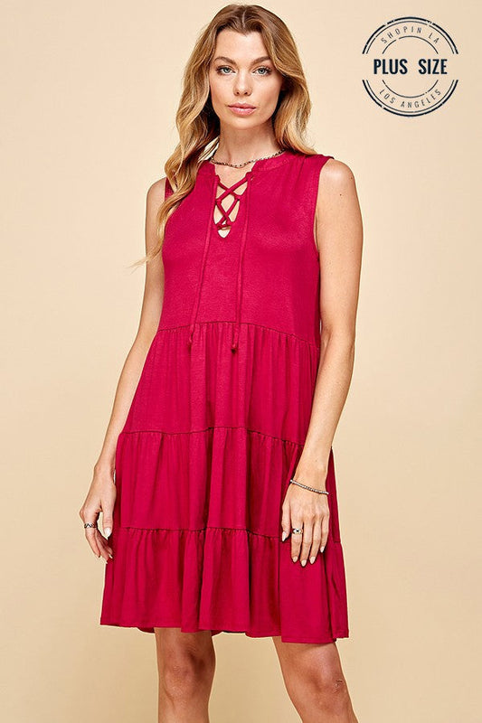 Solid plus size sleeveless dress with front lace and tiered design.