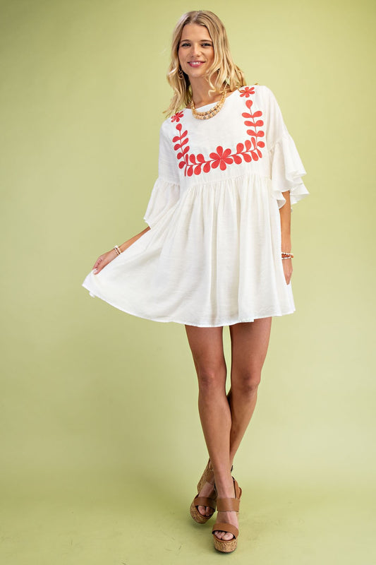 Coral Babydoll Mini Dress with delicate embroidery, perfect for any occasion.