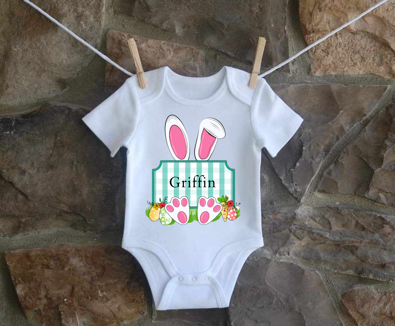 Personalized Easter Bunny infant shirt hanging on clothesline.