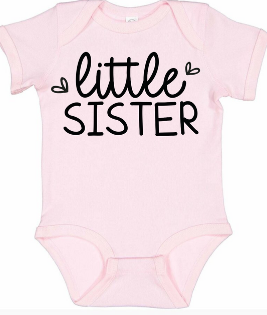 Pink baby onesie with "Little Sister" text and hearts.