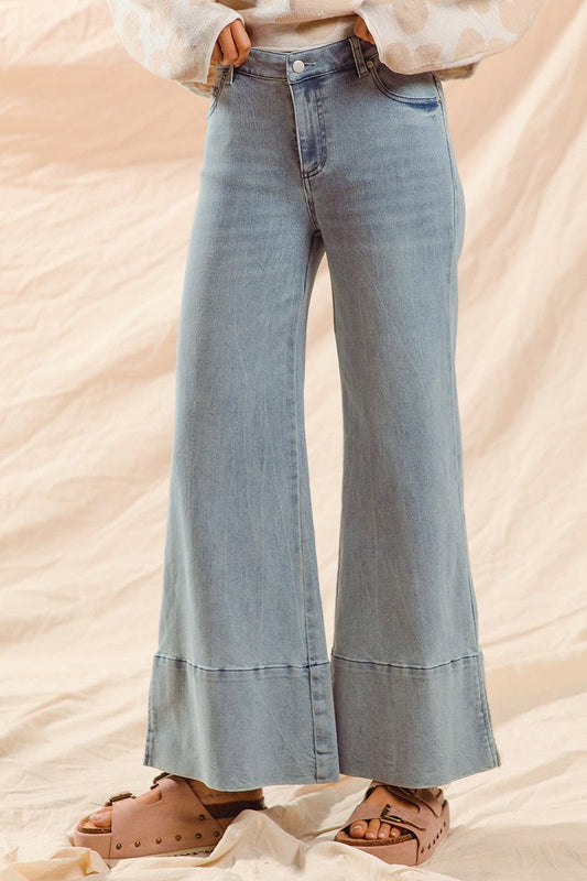 Wide leg flare denim jeans with side slits in light denim.