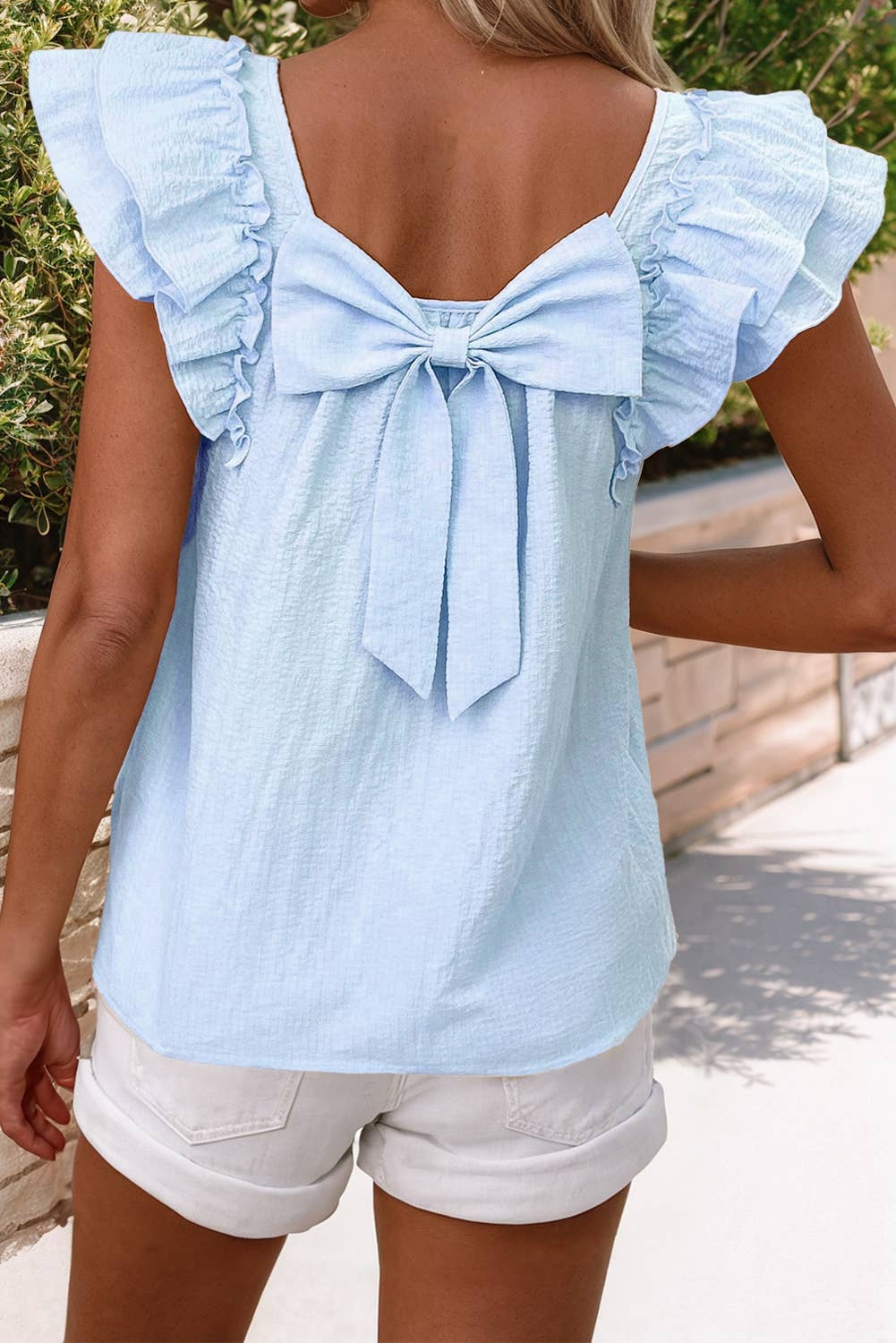 Textured bow knot frilled butterfly sleeve blouse in light blue, featuring elegant detailing and chic textured fabric.
