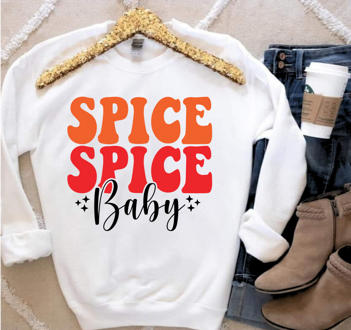 Spice Spice Baby shirt with bold orange and red text, styled with jeans, boots, and a coffee cup.