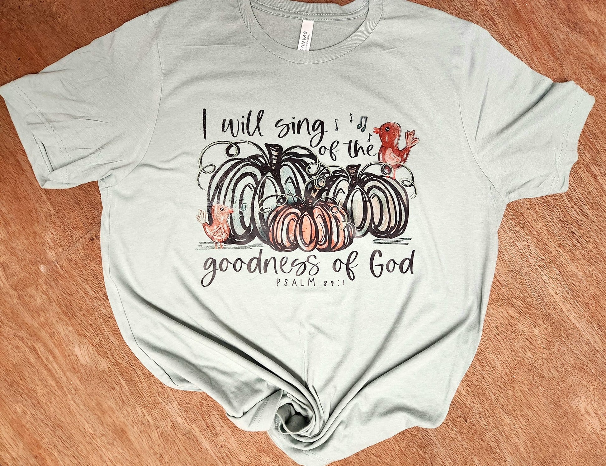 Shirt with "I Will Sing of The Goodness of God" text and fall pumpkin design.