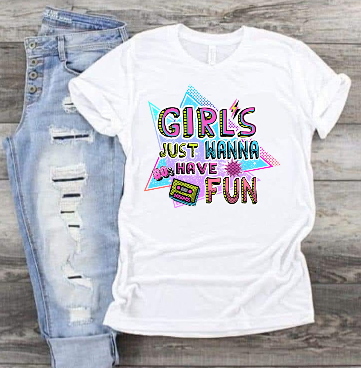80s-inspired "Girls Just Wanna Have Fun" T-shirt with playful print, paired with ripped jeans.