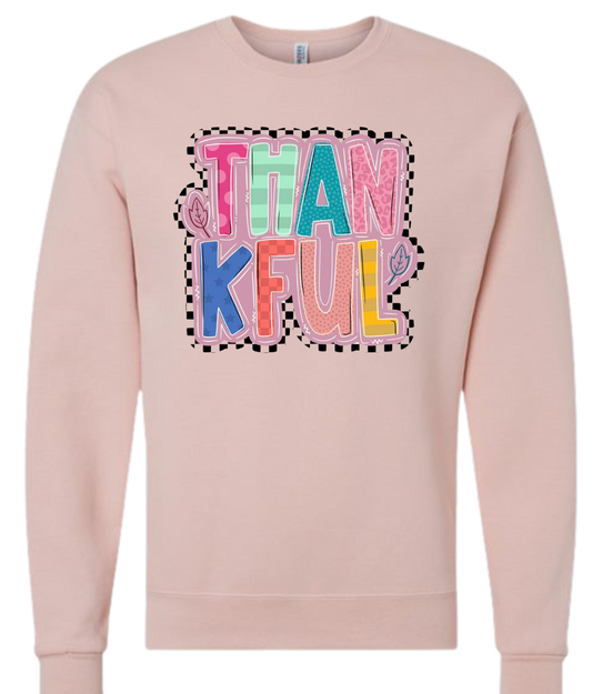 Thankful Shirt with colorful letters on a light pink sweatshirt.