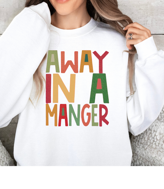 Away In A Manger holiday shirt with colorful festive lettering.
