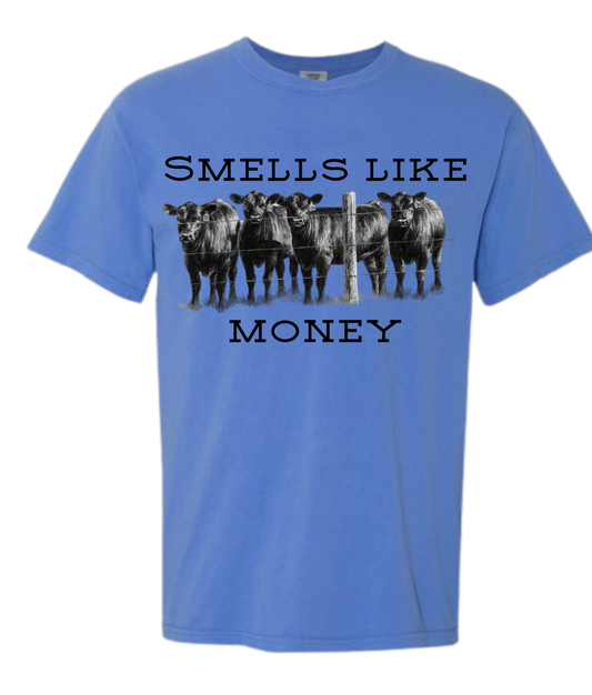 Smells Like Money t-shirt with cow design on blue background.