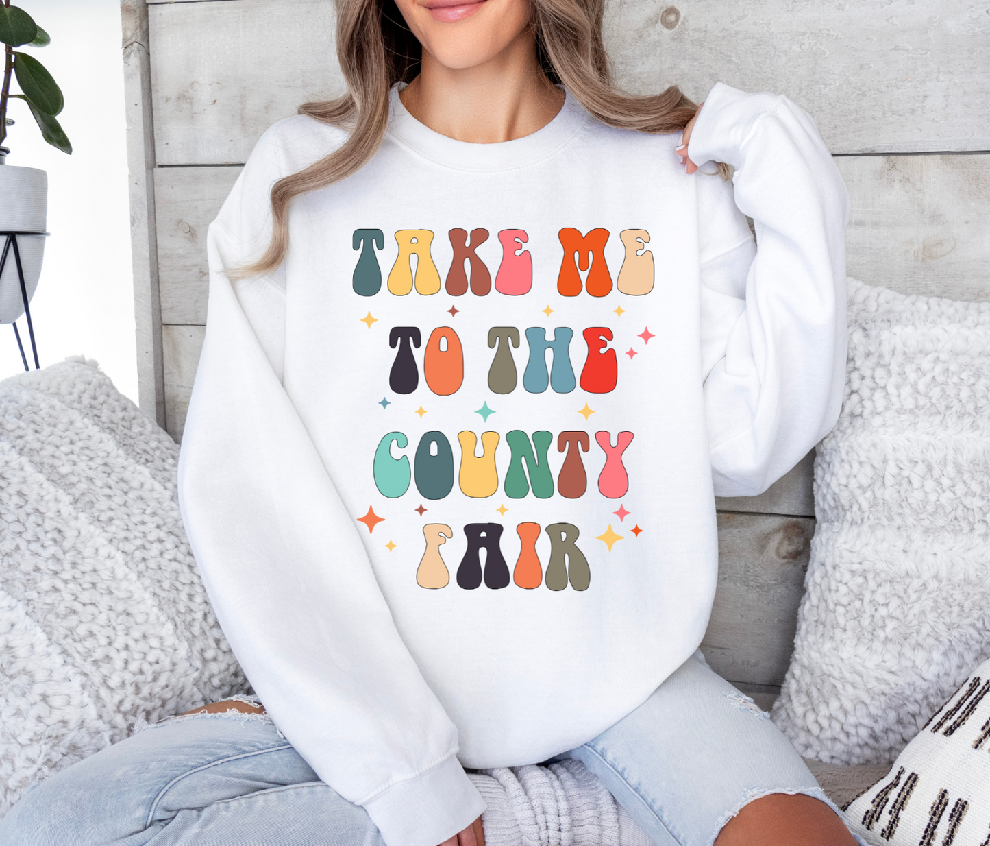 Take Me To The County Fair t-shirt with colorful letters, perfect for casual or fair-themed events.