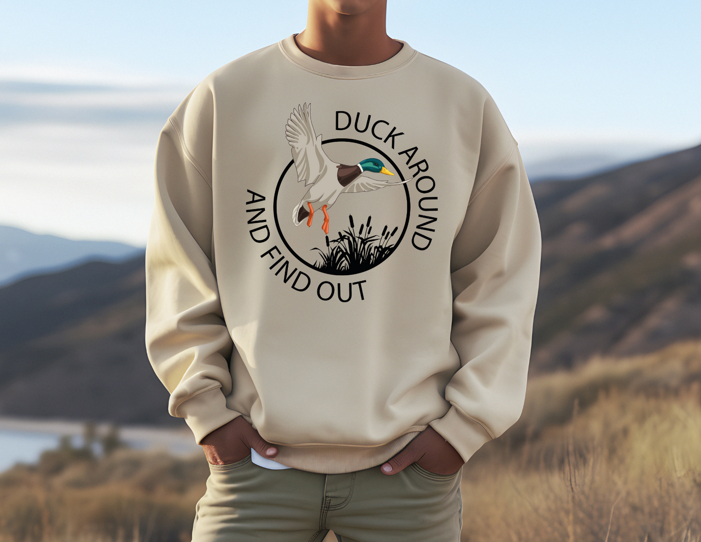 Duck Around & Find Out sweatshirt with whimsical duck design in natural setting.