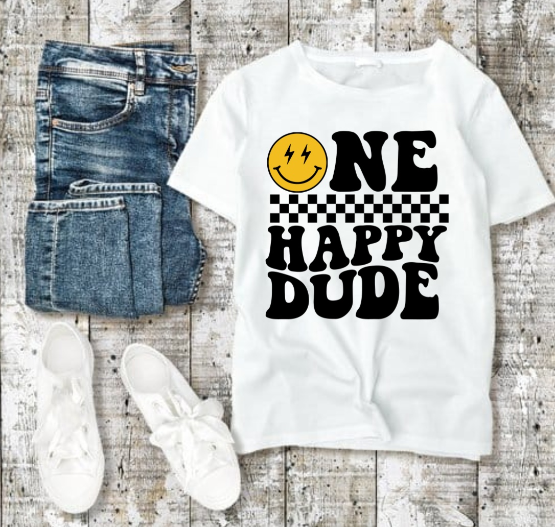 One Happy Dude Tshirt with smiley design, jeans, and sneakers on wooden background.