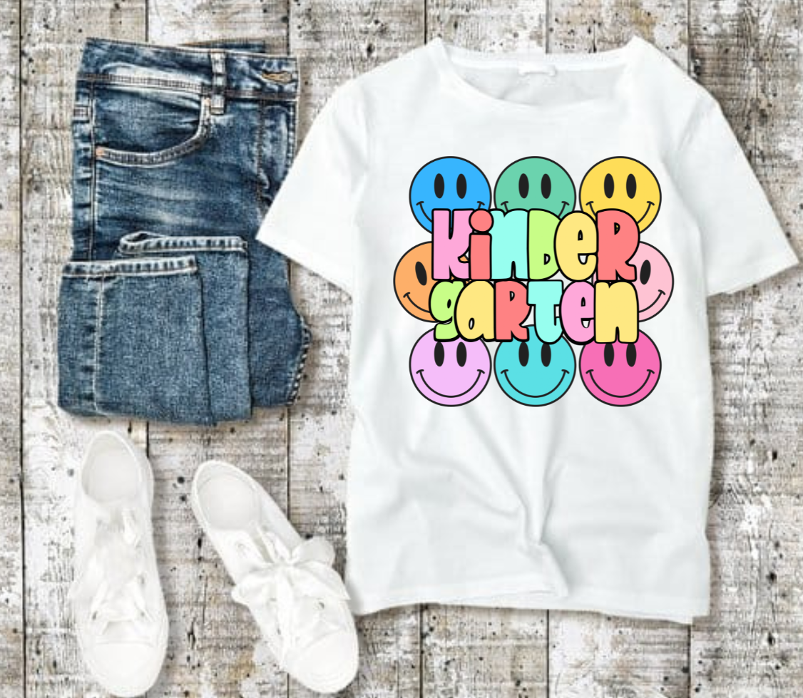 Kindergarten tshirt with colorful smiley faces and playful design.