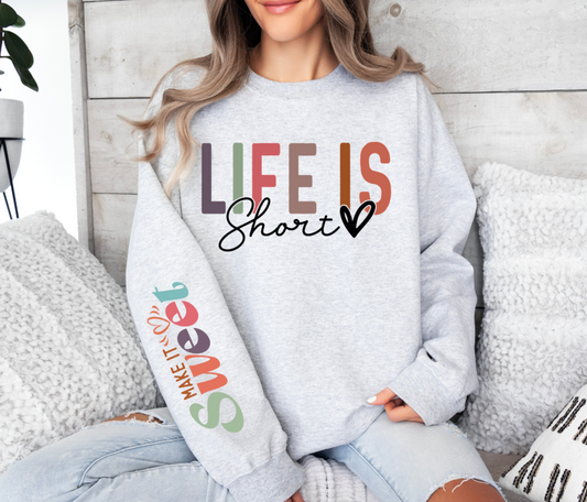 Sweatshirt with "Life Is Short Make It Sweet" design in colorful text.