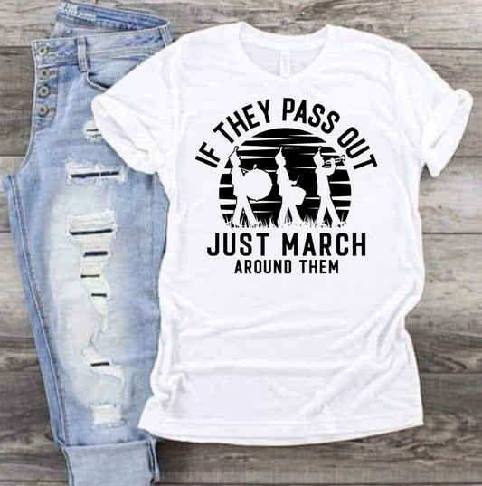 Gildan T-shirt with "If They Pass Out Just March Around Them" design, laid flat with jeans.
