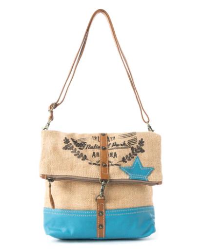 Grand Canyon Foldover Bag with teal leather and burlap texture, adjustable caramel leather strap, featuring Grand Canyon graphic.