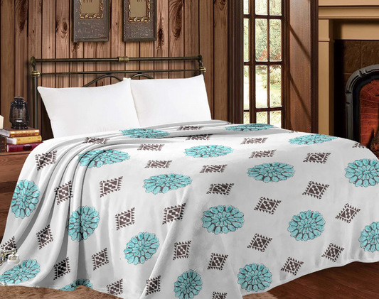 Mia Throw Blanket with western conchos design on bed in cozy room setting.