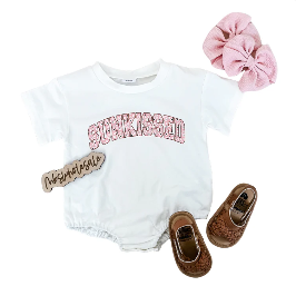 Suns Out Bubble Suit with accessories including pink hair bow and brown shoes.