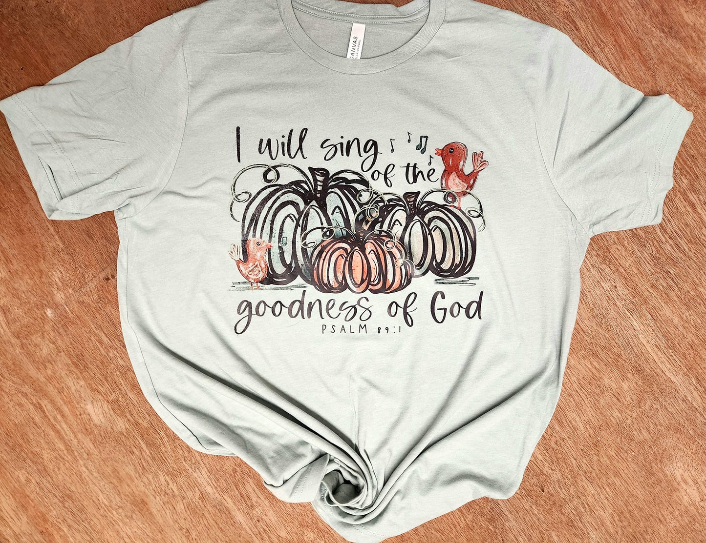 Shirt with "I Will Sing of The Goodness of God" text and fall pumpkin design.
