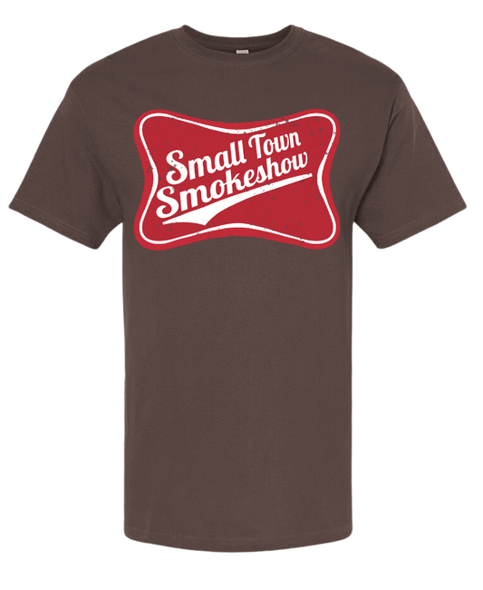 Small Town Smokeshow shirt with playful design on brown fabric.