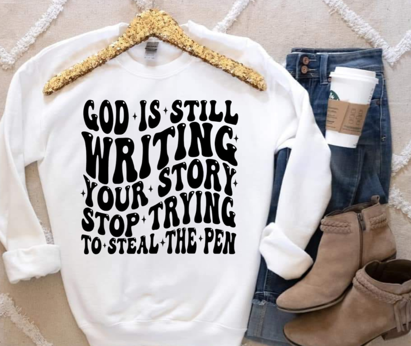 Gildan sweatshirt with "God Is Still Writing Your Story" message in black print.