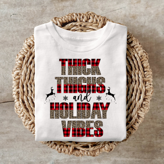 Thick Thighs and Holiday Vibes shirt with festive design on woven basket background.