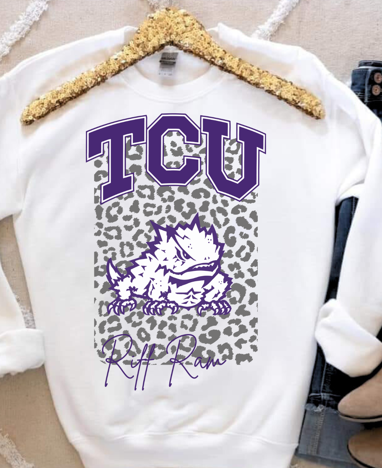 TCU Riff Ram sweatshirt with purple lettering and leopard print background.
