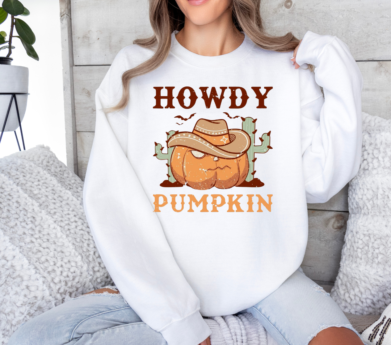 Howdy Pumpkin shirt featuring pumpkin with cowboy hat and cactus design.