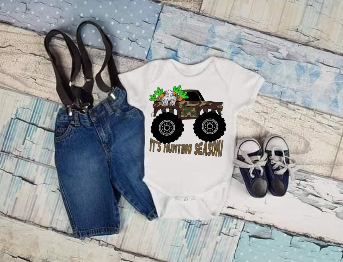 Hunting Season shirt for Easter with camo truck design, displayed with denim shorts and shoes.