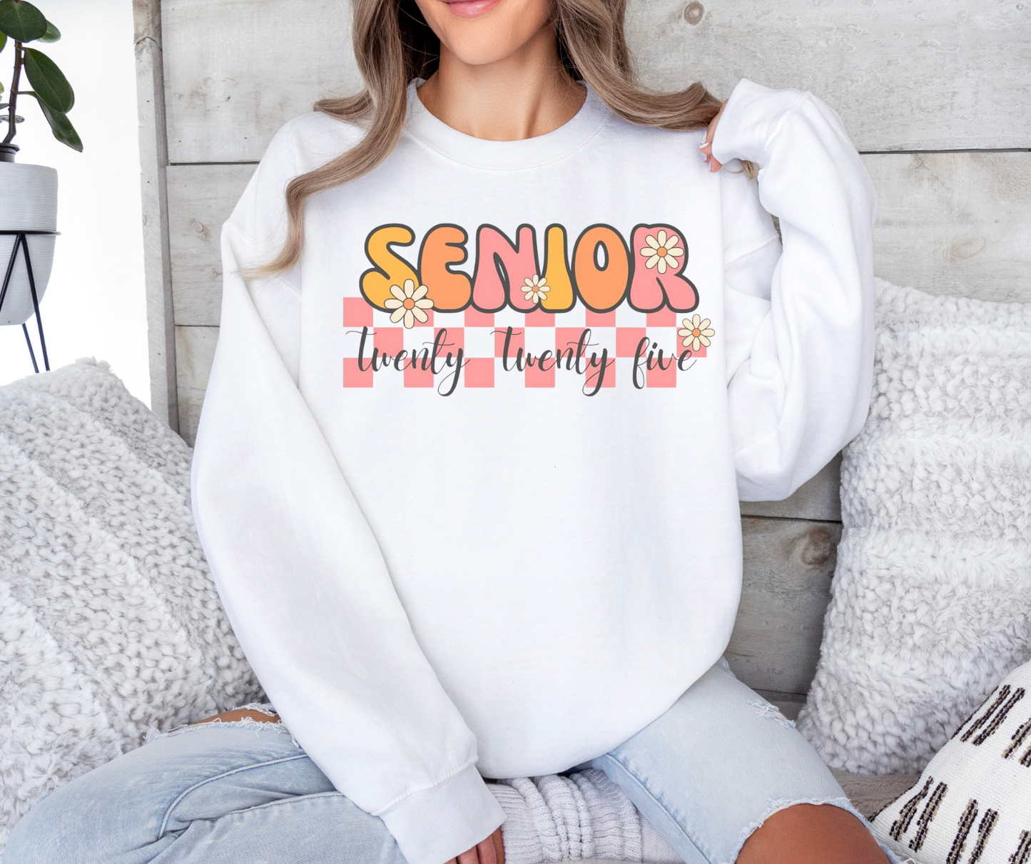 Senior 2025 T-shirt with colorful floral design on a woman sitting.