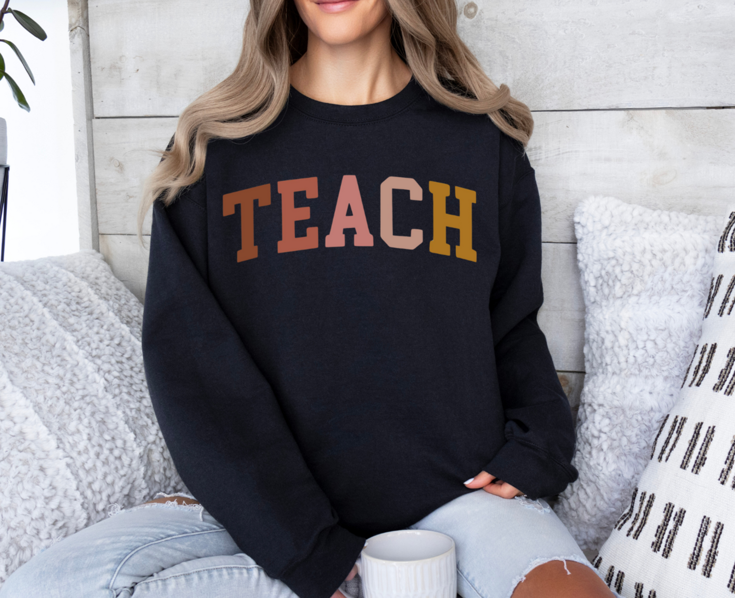 Gildan sweatshirt with "Teach" text in colored letters, 50/50 blend or 100% cotton.