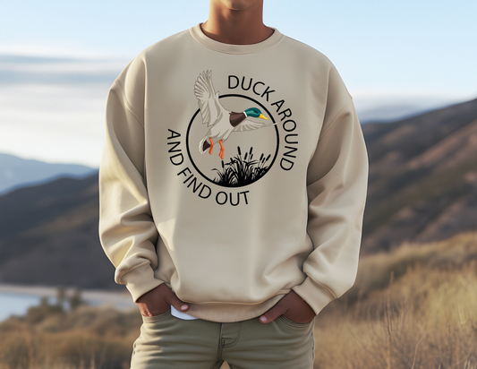 Duck Around & Find Out sweatshirt with whimsical duck design in natural setting.