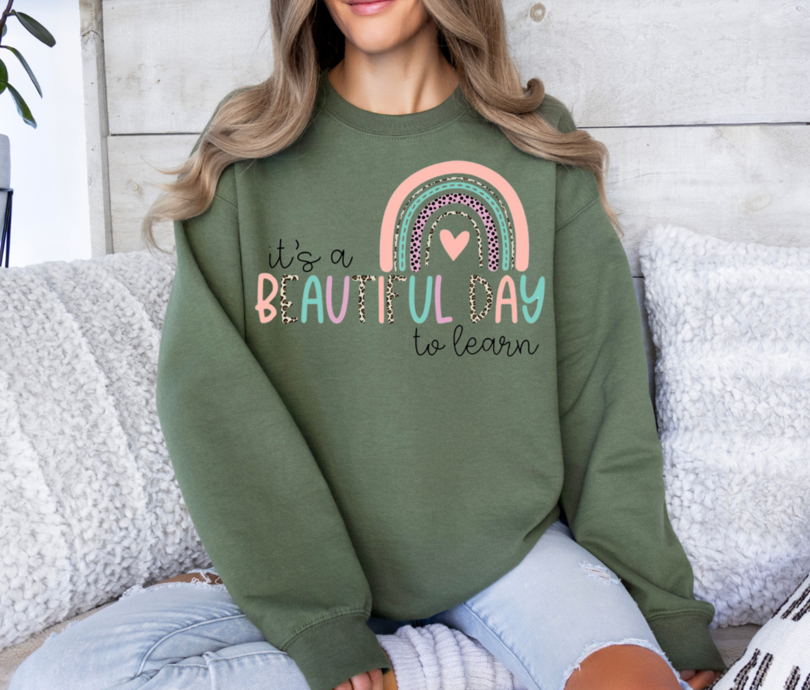 Sweatshirt with "It's a Beautiful Day to Learn" design in green.