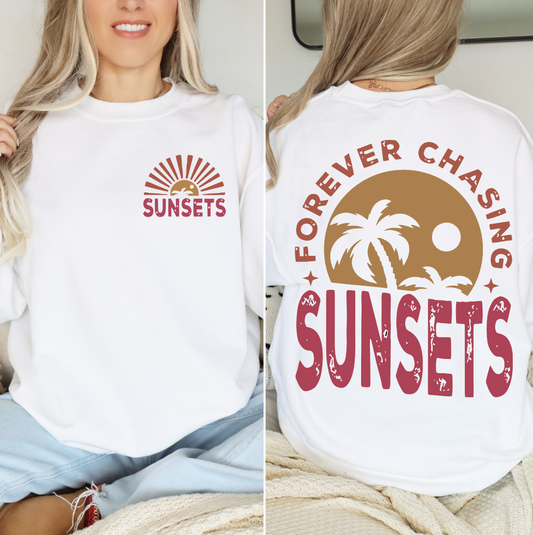Forever Chasing Sunsets sweatshirt with vibrant sunset and palm tree design.
