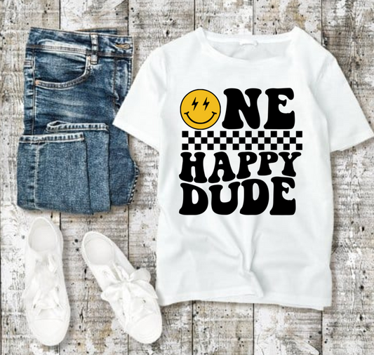 One Happy Dude Tshirt with smiley design, jeans, and sneakers on wooden background.