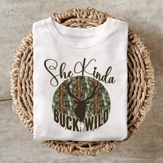 Kinda Buck Wild shirt with bold design featuring antlers and forest background.
