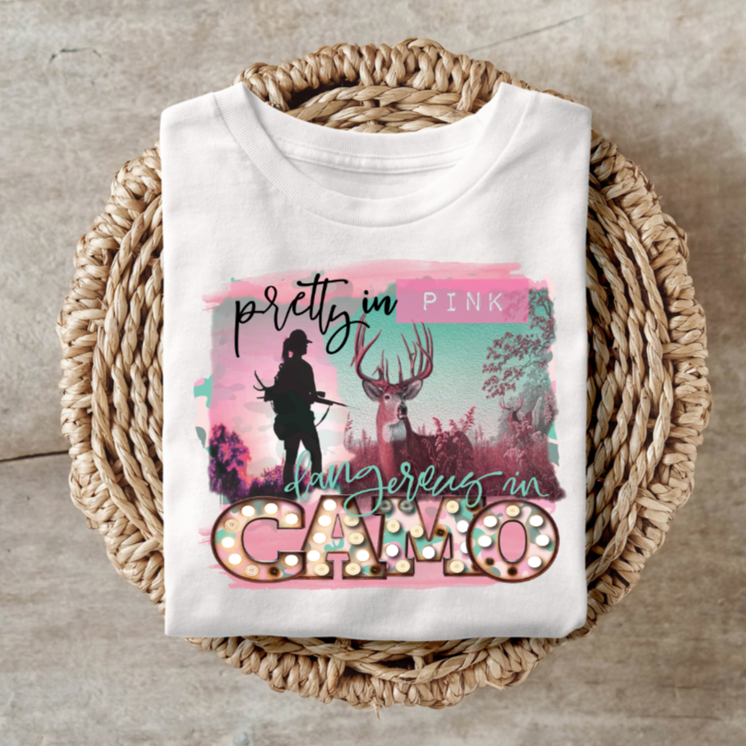 Pretty in Pink Dangerous in Camo shirt with edgy design featuring a silhouette and camo elements.