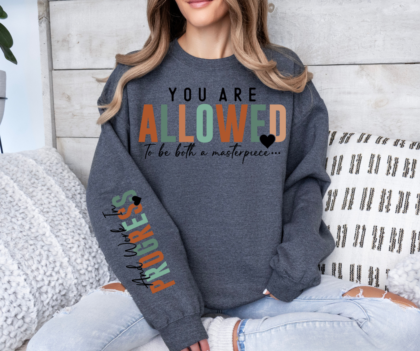 Sweatshirt with "You Are Allowed To Be Both a Masterpiece and Work In Progress" text design, Gildan brand, cotton blend.