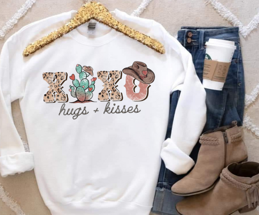 Hugs & Kisses Gildan sweatshirt, 50/50 blend, displayed with jeans and boots.