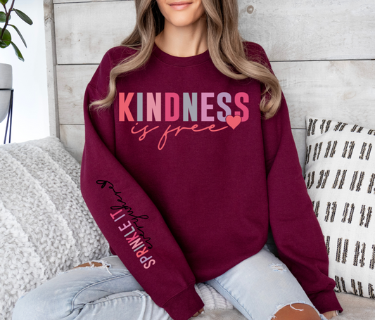 Burgundy sweatshirt with "Kindness is Free Sprinkle it Everywhere" design.