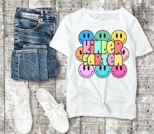 Kindergarten tshirt with colorful smiley faces and playful design.