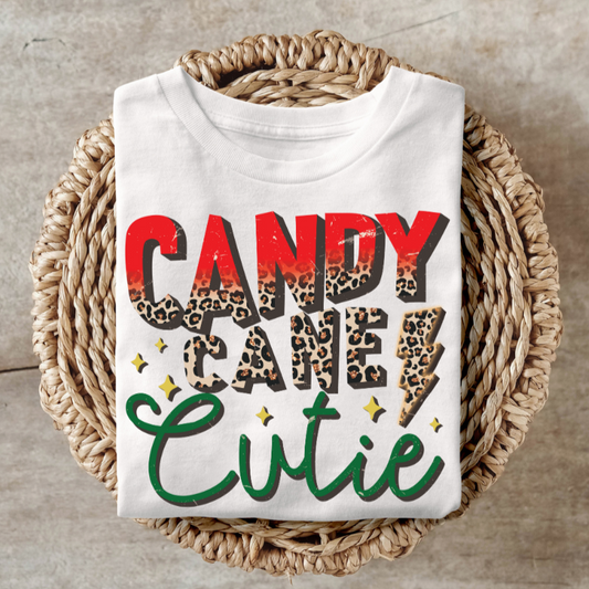 Candy Cane Cutie shirt with festive design on woven basket.